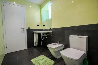 a bathroom with a toilet and a sink at Catalunya Casas Modern Hilltop Haven with private pool 7km to beach in Castellet