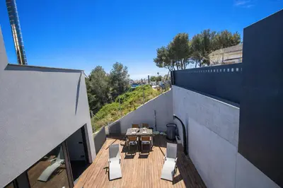 a balcony with a table and chairs on a building at Catalunya Casas Modern Hilltop Haven with private pool 7km to beach in Castellet