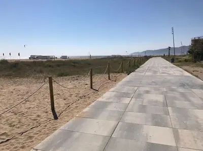 a rope fence on the side of a beach at BEACHFRONT APARTMENT Castelldefels in Castelldefels