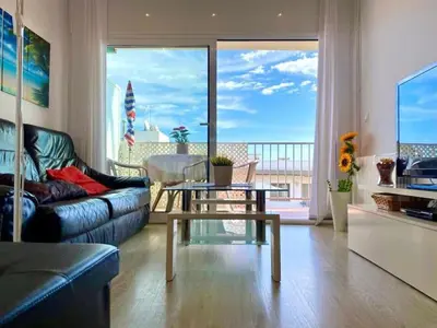 a living room with a couch and a table at BEACHFRONT APARTMENT Castelldefels in Castelldefels