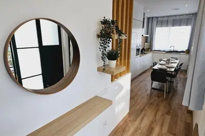 a mirror on a wall in a kitchen with a table at apartamento premium muy cerca ciudad Barcelona in Badalona