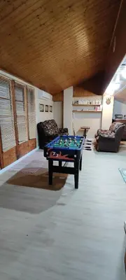 a living room with a pool table in the middle at CAL LLOP in Sant Cugat de Sesgarrigues
