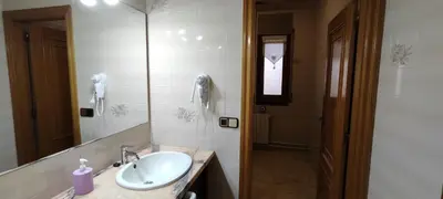 a bathroom with a sink and a mirror and a phone at CAL LLOP in Sant Cugat de Sesgarrigues