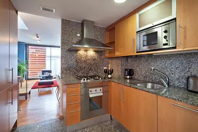 a kitchen with a sink and a stove top oven at My Space Emirates - Park Güell Triplex with Private Terrace in Barcelona