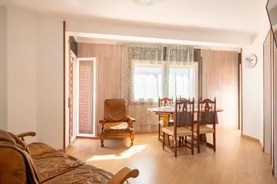 a living room with a dining room table and chairs at Apartamento 3 hab 15 minutos de Barcelona centro y 5 minutos playa in Sant Adria de Besos