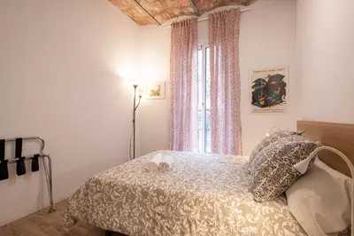 a bedroom with a bed and a window at Centric Apartment Molino P3 in Barcelona