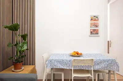 a dining room with a table with a bowl of fruit at Centric Apartment Molino P3 in Barcelona