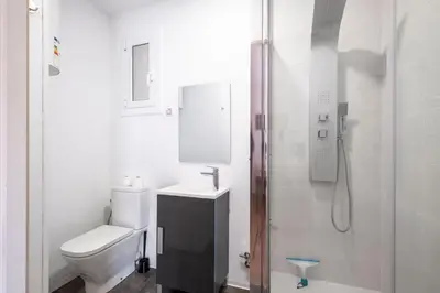 a white bathroom with a toilet and a shower at Centric Molino Theatre 1-1 in Barcelona