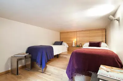 a bedroom with two beds with purple blankets at My Space Emirates - Charming Duplex in Barcelona ideal for Families or Friends in Barcelona