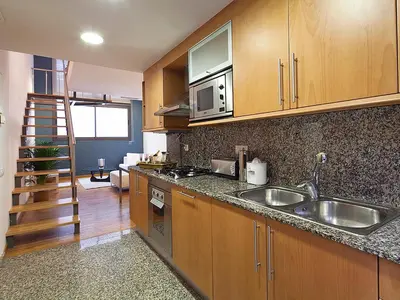 a kitchen with a sink and a microwave at My Space Emirates - Charming Duplex in Barcelona ideal for Families or Friends in Barcelona