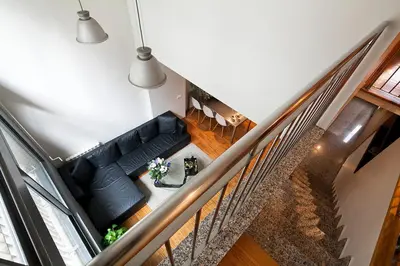 an overhead view of a living room with a black couch at My Space Emirates - Charming Duplex in Barcelona ideal for Families or Friends in Barcelona