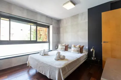 a bedroom with a bed with white towels on it at My Space Emirates - Splendid Apartment with Terrace and Pool near Park Güell in Barcelona