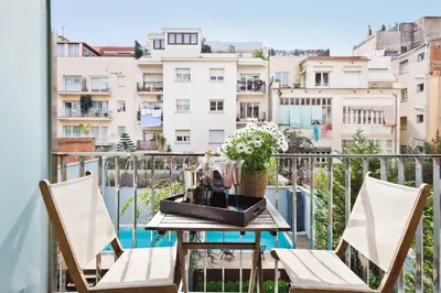 a table on a balcony with a view of buildings at My Space Emirates - Executive Apartments with Private Balcony in Barcelona