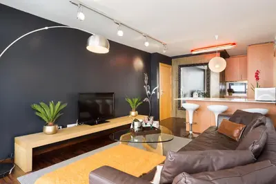 a living room with a couch and a television at My Space Emirates - Executive Apartments with Private Balcony in Barcelona