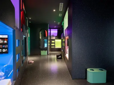 a hallway of a room with a room with purple lights at AMISTAT City Hostel Barcelona in Barcelona