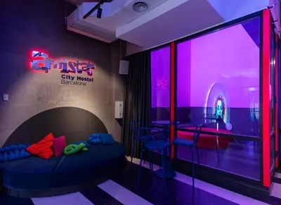 a room with a bed and a bar with purple lights at AMISTAT City Hostel Barcelona in Barcelona