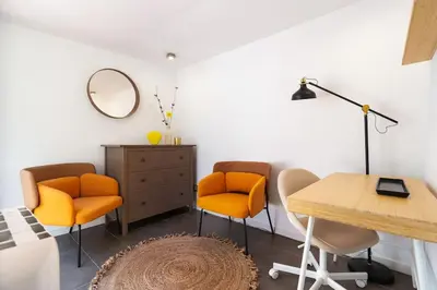 a room with two chairs and a table and a mirror at Enamorats Glorias in Barcelona