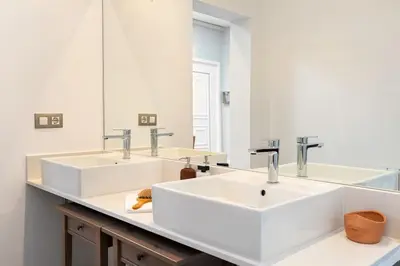 a bathroom with two sinks and a mirror at Enamorats Glorias in Barcelona