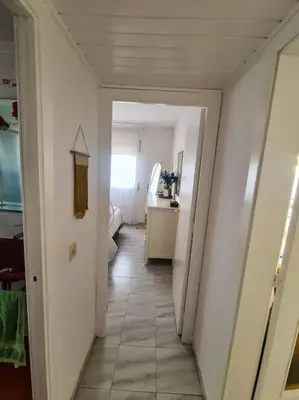 a hallway leading to a room with a bathroom at Nice beachside 2-BD apt near Barcelona in Cunit