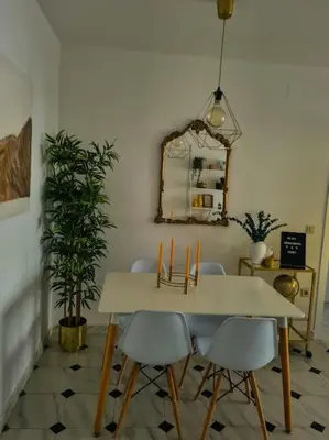 a dining room table with chairs and a mirror at Nice beachside 2-BD apt near Barcelona in Cunit
