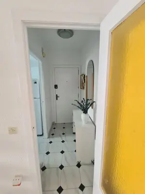 a hallway with a white and black tiled floor at Nice beachside 2-BD apt near Barcelona in Cunit