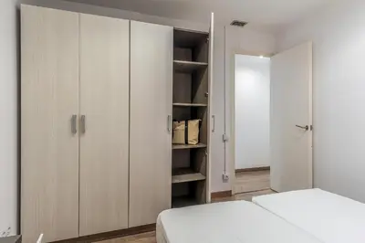 a bedroom with white cabinets and a bed at AB Margarit Apartments in Barcelona