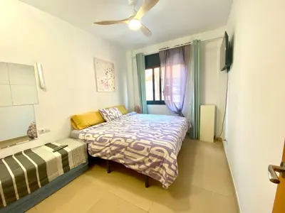 a small bedroom with a bed and a window at Estancias mensuales Terrassa in Terrassa