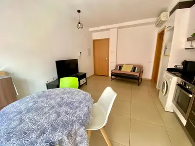 a kitchen and living room with a table and chairs at Estancias mensuales Terrassa in Terrassa