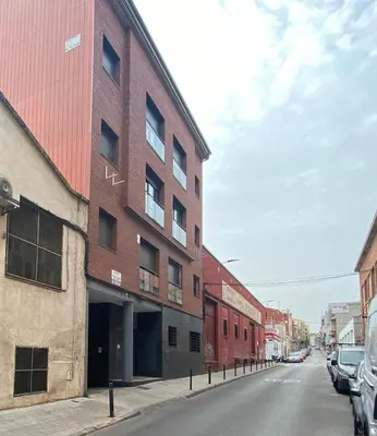 an empty street with a red brick building at Estancias mensuales Terrassa in Terrassa