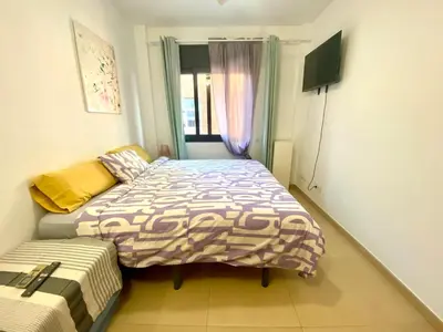 a bedroom with two beds and a window at Estancias mensuales Terrassa in Terrassa