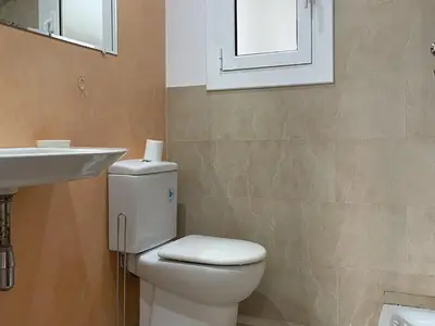 a bathroom with a toilet and a sink at Apartment Picasso in Vilanova i la Geltrú