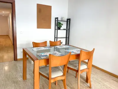 a dining room table with two chairs and a table at Apartment Picasso in Vilanova i la Geltrú