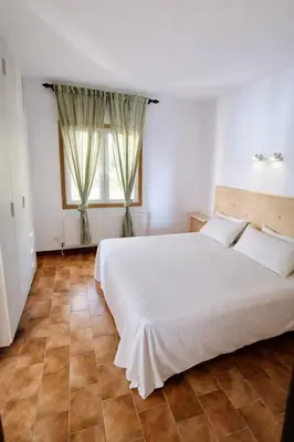 a bedroom with a large white bed and a window at Catalunya Casas Ultimate tranquility in rural Costa Brava! in Tordera