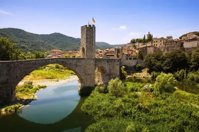 an old bridge over a river in a town at Catalunya Casas Ultimate tranquility in rural Costa Brava! in Tordera