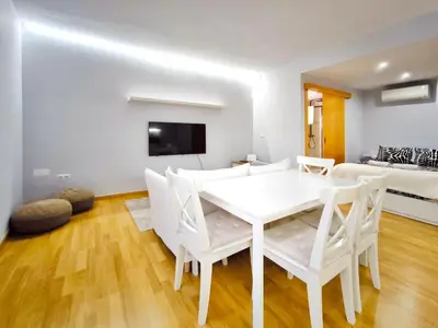 a white dining room with a white table and chairs at Moderno apartamento tipo loft en Terrassa centro in Terrassa