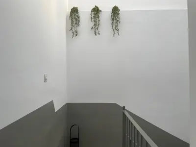 a staircase with wreaths hanging on a white wall at Barri Vell 4 in Manresa
