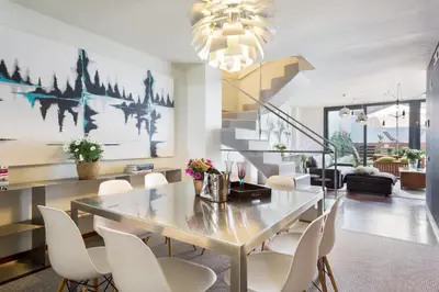 a dining room with a table and chairs at My Space Emirates - Modern Duplex with Private Garden and Swimming Pool in Barcelona