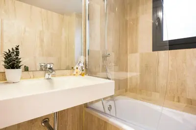 a bathroom with a sink and a shower at My Space Emirates - Modern Duplex with Private Garden and Swimming Pool in Barcelona