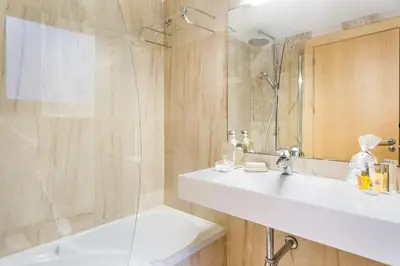 a bathroom with a sink and a shower at My Space Emirates - Modern Duplex with Private Garden and Swimming Pool in Barcelona