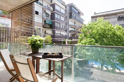 a table and chairs on a balcony with a view of a building at My Space Emirates - Spacious Apartments near the City Center in Barcelona