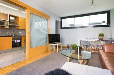 a living room with a couch and a table at My Space Emirates - Spacious Apartments near the City Center in Barcelona