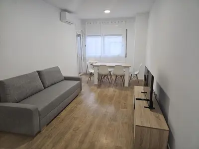 a living room with a couch and a table at Vilamarlux VIII in Vilassar de Mar