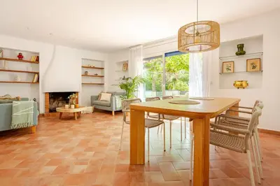 a dining room with a table and a living room at SITGES Masia Sències in Sitges