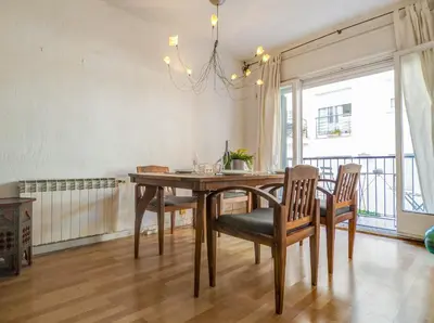 a dining room table with chairs and a chandelier at Araia Apartment by Hello Homes Sitges in Sitges