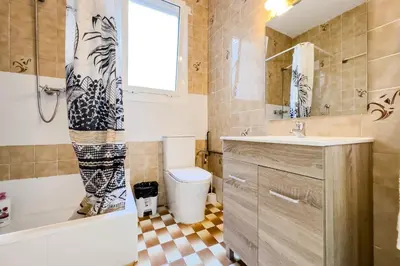 a bathroom with a toilet and a sink and a tub at Bed&BCN Mas Apartments in Hospitalet de Llobregat
