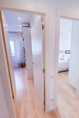 a hallway with white doors and a bedroom at Anna & Thomas - Sitges Center Apt in Sitges