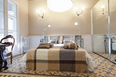 a bedroom with a bed with two cats on it at My Space Emirates - Apartments in Rambla de Catalunya in Barcelona