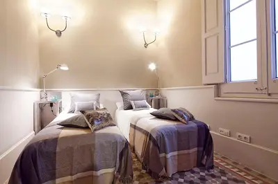 a bedroom with two beds with blankets and a window at My Space Emirates - Apartments in Rambla de Catalunya in Barcelona