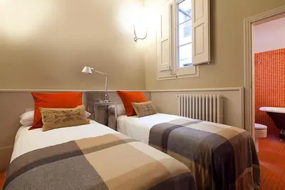 two beds sitting next to each other in a room at My Space Emirates - Apartments in Rambla de Catalunya in Barcelona
