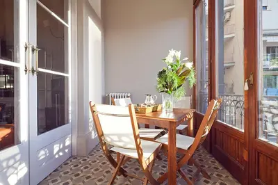 a wooden table and chairs on a balcony at My Space Emirates - Apartments in Rambla de Catalunya in Barcelona